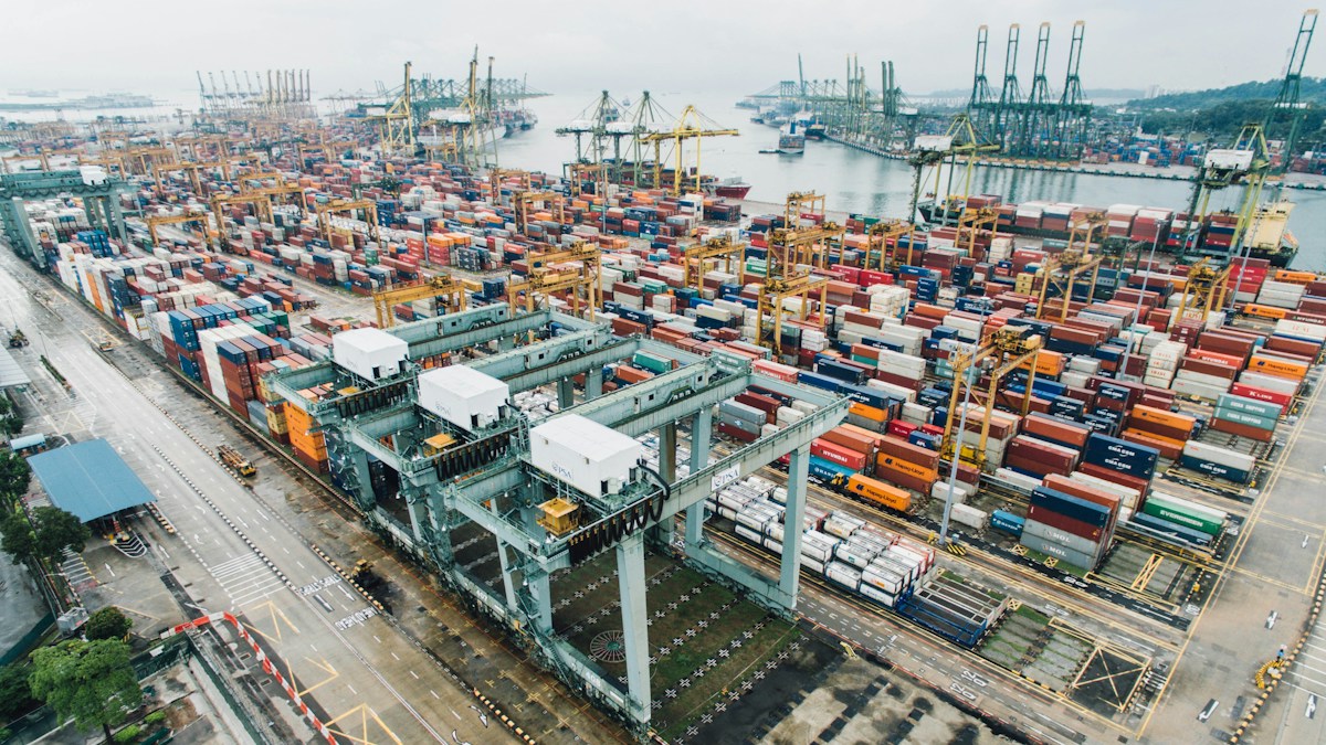 Modern dual-fuel container vessel at deepwater port terminal